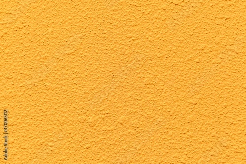 Patterned cement wall Vintage yellow painted texture and background