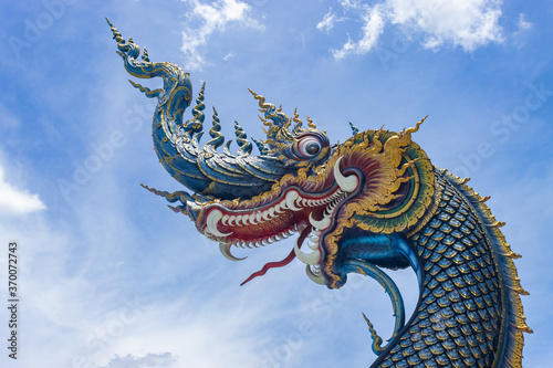 Chiangrai  Thailand - June 7  2020  Blue Serpent or Naga on Blue Sky Background with Natural Light in Wat Rong Suea Ten Temple at Chiangrai Thailand in Zoom View