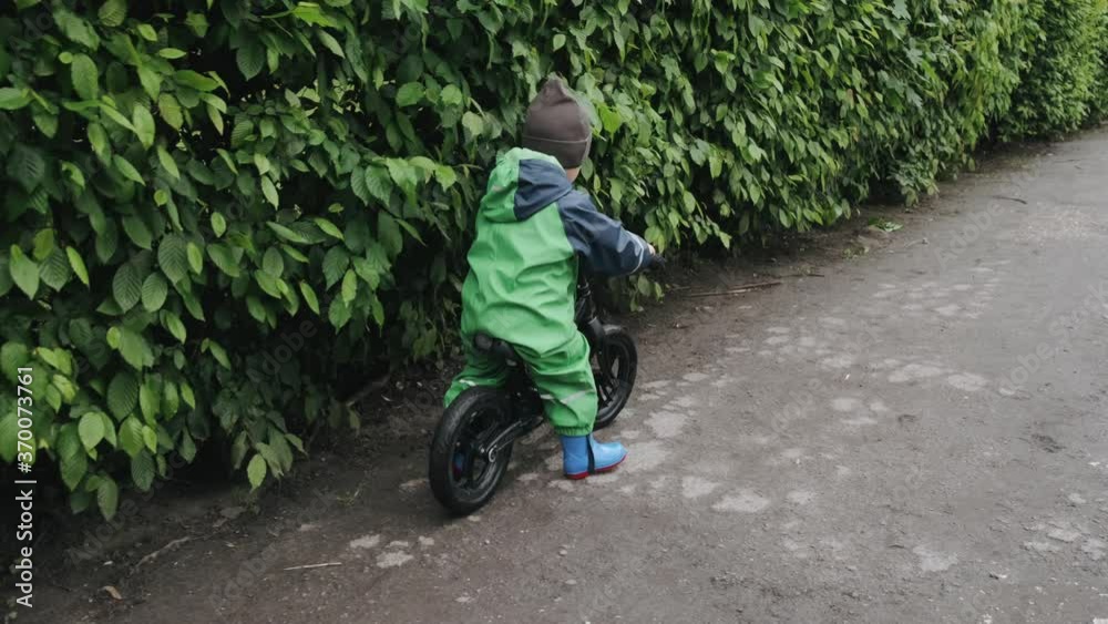 Kids in a puddle. Child having fun outdoors. Boy with bicycle. Kids in a puddle. Child having fun outdoors. Boy with bicycle.