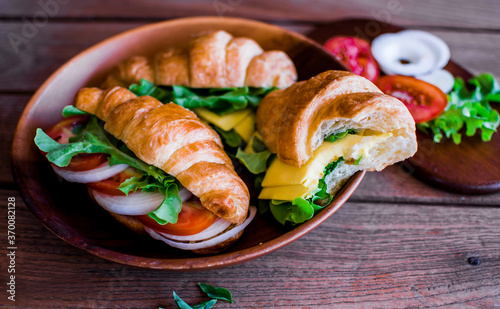 Freshly croissant sandwich on wooden background. It is a type of French pastry suitable as breakfast.