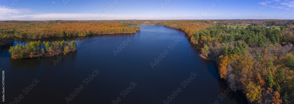 Fototapeta premium Ashland Reservoir aerial view panorama with fall foliage in Ashland State Park in town of Ashland, Massachusetts MA, USA. 
