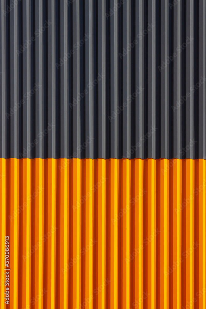 Plakat A corrugated fence of yellow and grey metal sheets. Texture of metal fence picket Profile decking. Internal primed side of a metal picket fence. Profiled metal.