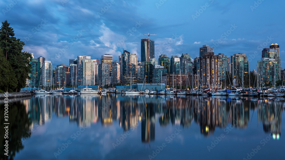 Blue hour Reflection of Vancouver city, BC,  from the Marina at Stanley park, one of the most beautiful urban park in the world.