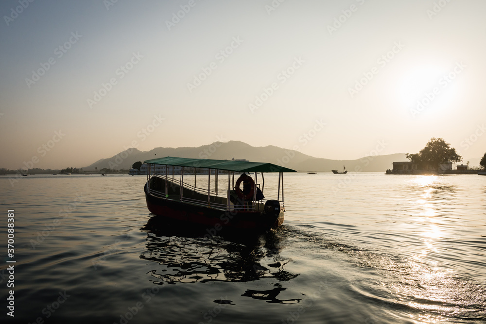 Boat on Lake Pichola at sunset in Udaiur, India
