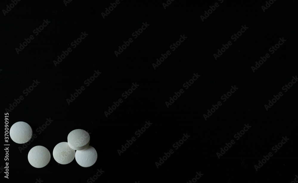 Tabletas o pastillas blancas sobre un fondo negro para mostrar información o algún producto Tabletas o pastillas blancas sobre un fondo negro para mostrar información o algún producto