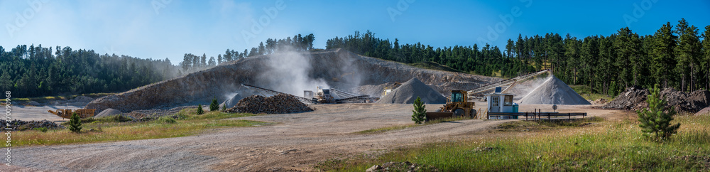 Open pit sand and gravel quarry with heavy equipment