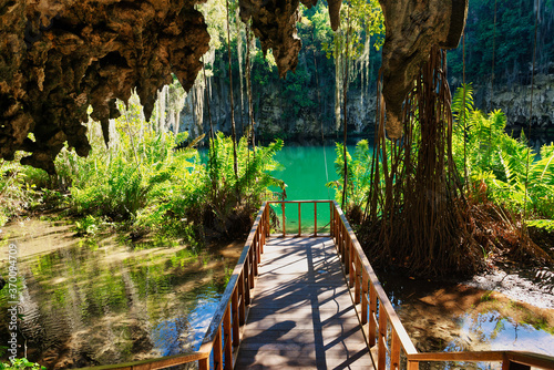 Magnificent view of the mystery misty cave in the jungle,  in the underground lake. The 3 Eyes National Park (Los Tres Ojos) in Santo Domingo, Caribbean, Dominican Republic photo