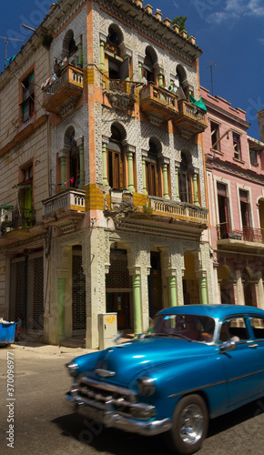 Cuban car with a building in the background in the city of la Havana, Cuba