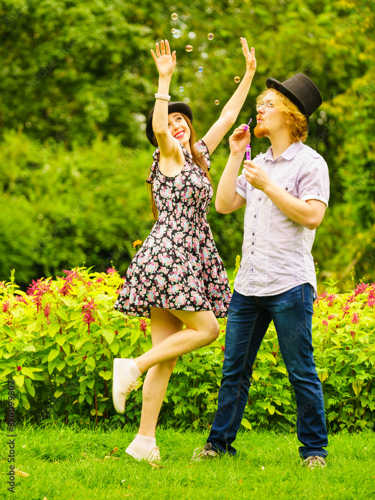 Obraz premium Couple blowing bubbles outdoor