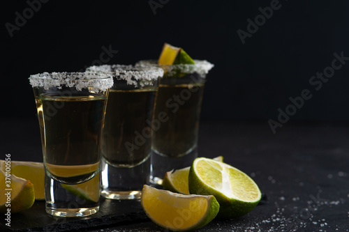 Mexican Gold Tequila with lime slices and salt.