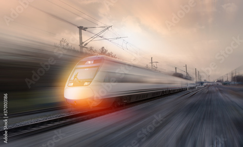 High speed train runs on rail tracks . Train in motion