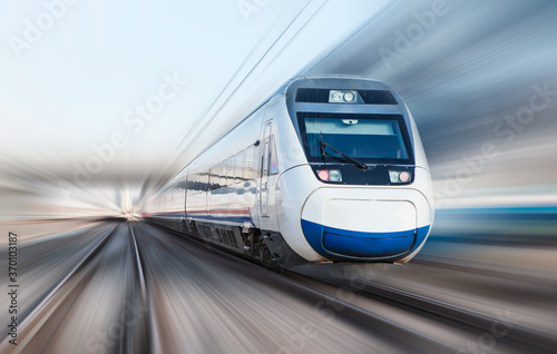 Fototapet High speed train runs on rail tracks . Train in motion
