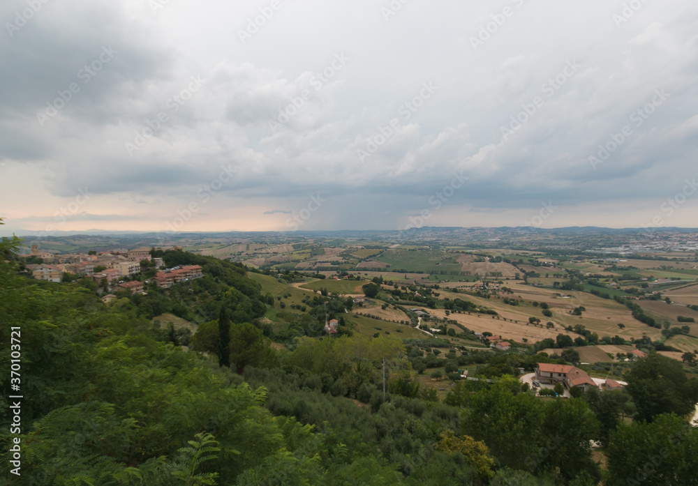 Panoramic view from Recanati, city of the infinity, with summer storm in the Marche region