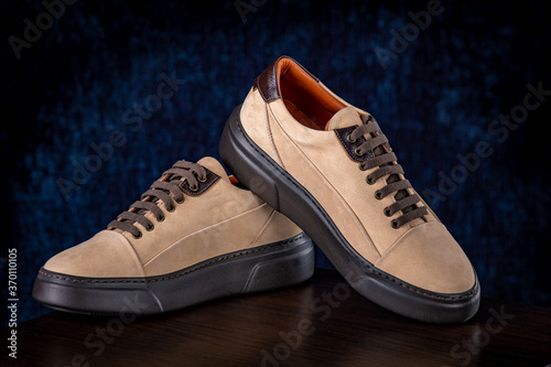 Brown men's lather shoes on blue background