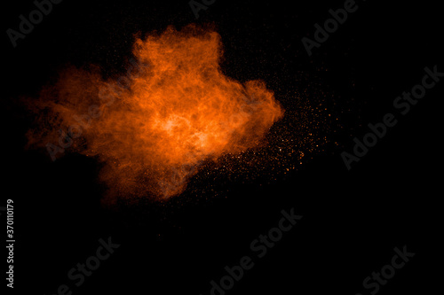 Orange powder splattered on white background.Abstract dust cloud  backdrop. © Pattadis