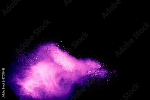 Pink dust particles splash on black background.Pink powder splash.