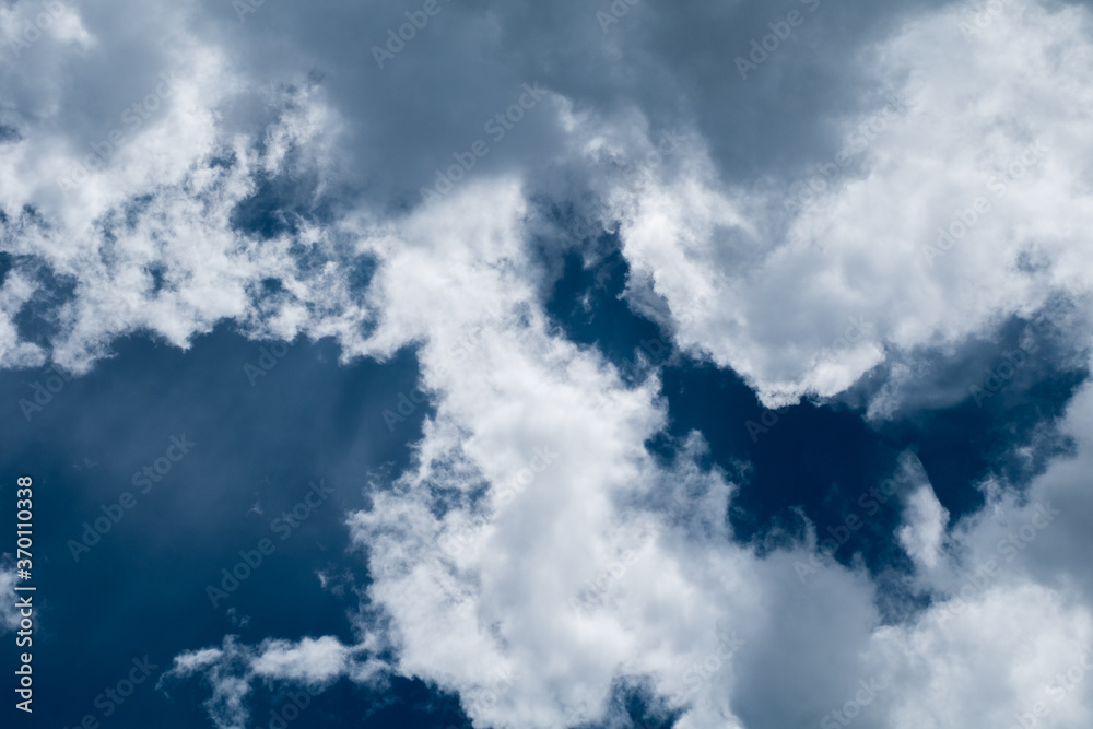 floating white cloud in bright blue sky in sunny day