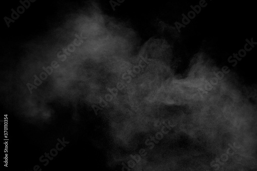 White powder explosion clouds.Freeze motion of white dust particles splash on black background.