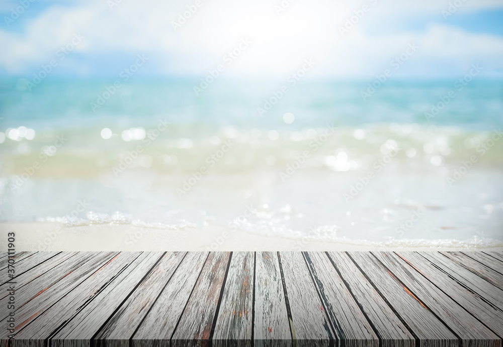 Wood perspective on sand beach with sea cocept. over light of old wood table on blur image of ocean with bokeh and sky. for travel summer holidays. Wood perspective on sand beach with sea cocept. over light of old wood table on blur image of ocean with bokeh and sky. for travel summer holidays.