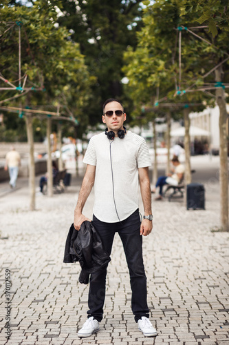 Smiling man with headphone in his neck, look in camera © Роман Котиков