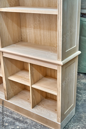 Modern joinery. Wooden bookcases in process of production in workshop. Furniture manufacture
