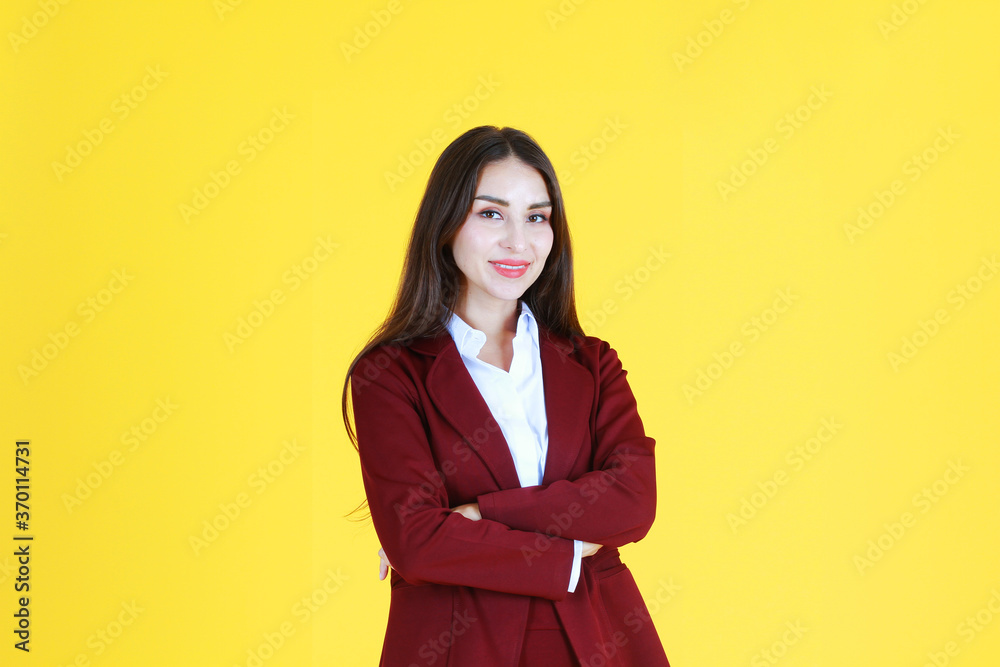 Business Caucasian woman in red suit smiling and smart isolated on yellow background. Business Caucasian woman in red suit smiling and smart isolated on yellow background.