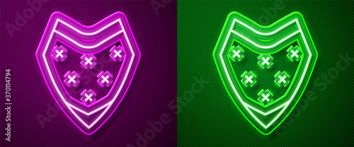 Glowing neon line Traditional mexican poncho clothing icon isolated on purple and green background. Vector.