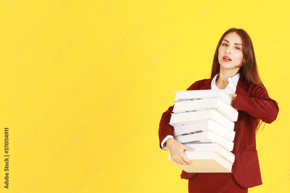 Businesswoman in red suit hand holding document books isolated on yellow background. Copy Space Businesswoman in red suit hand holding document books isolated on yellow background. Copy Space