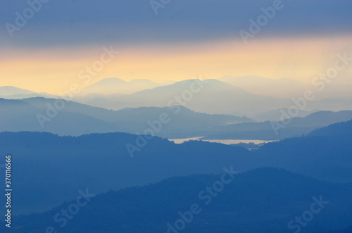 Foggy layered mountain landscape in North of Thailand © panthawat
