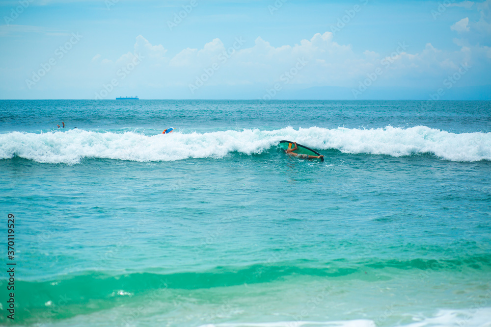 The guy is swimming on the surf board on the ocean. Healthy active lifestyle in summer vocation. The guy is swimming on the surf board on the ocean. Healthy active lifestyle in summer vocation.