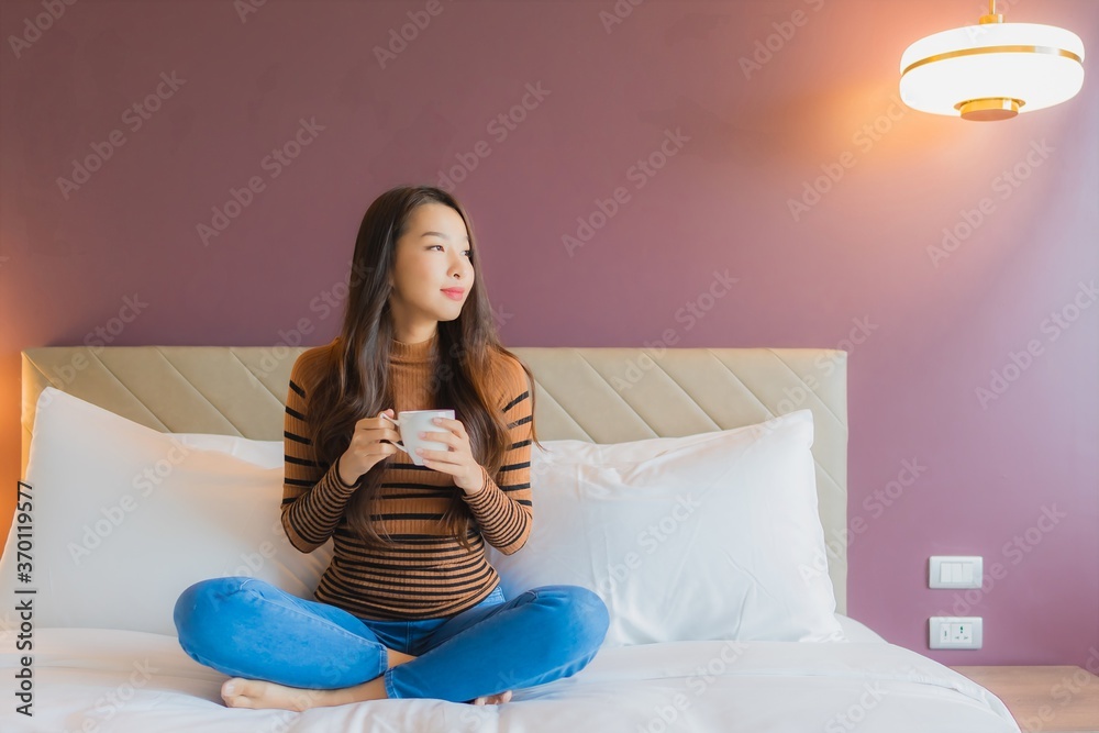 Portrait beautiful young asian woman with coffee cup on bed Portrait beautiful young asian woman with coffee cup on bed