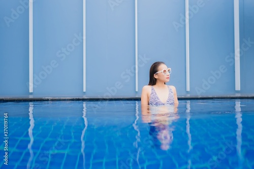 Portrait beautiful young asian woman relax smile around outdoor swimming pool