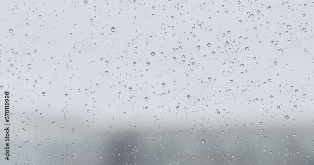 Slow motion background with raindrops on window glass Slow motion background with raindrops on window glass