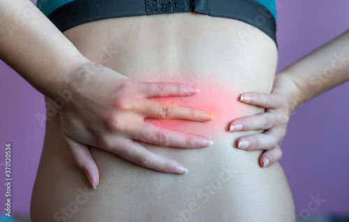 Wallpaper Mural young woman holding  red inflamed back , back ache or back injury. Torontodigital.ca