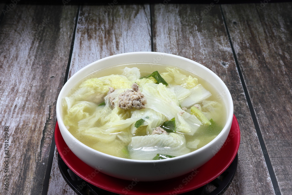 Traditional clear soup of Chinese cabbage and marinated (minced) pork in the bowl. Famous hot and freshness soup menu in Chinese restaurant. Traditional clear soup of Chinese cabbage and marinated (minced) pork in the bowl. Famous hot and freshness soup menu in Chinese restaurant.