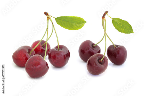 Black sweet cherry with leaves isolated on a white background