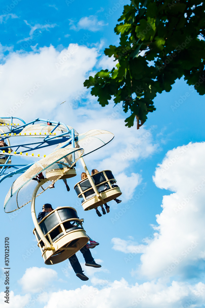 Ride carousel in motion in amusement park at sunny day Ride carousel in motion in amusement park at sunny day