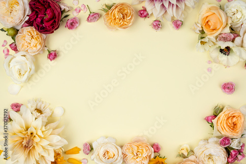 Romantic heart made of a mix of fresh flowers. Colorful floral bloom inspired by special occasions. Wedding card emblazoned with flowers on a white background.