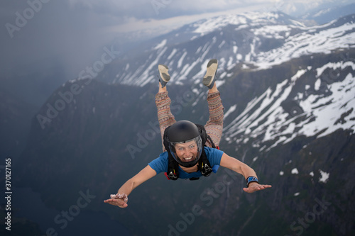 Skydivers over snowy mountains in Norway