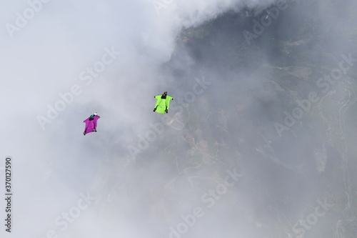 Skydivers over snowy mountains in Norway