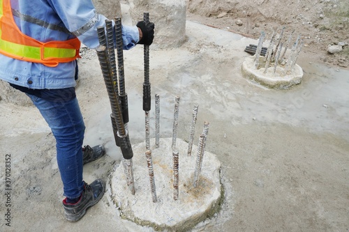 Workers are putting couplers to connect the rebar at the construction site. photo