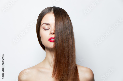 Attractive woman Hair covers half of the face  closed eyes bright makeup 