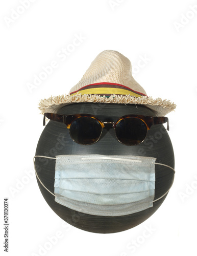 Mannequin head with sunglasses in a hat and in a protective mask isolated on a white background.