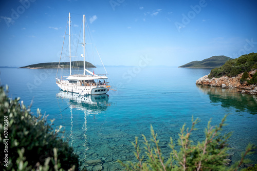 Beautiful seascape, a white yacht stands on the shore of the turquoise Mediterranean Sea