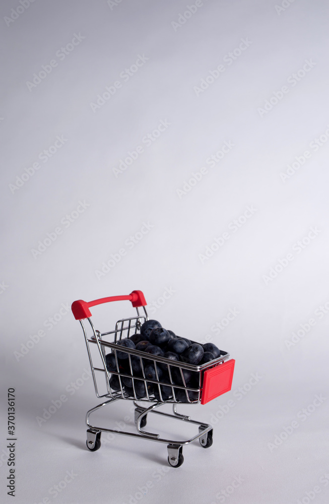 metal cart with blueberries on a white background with a copy of the space. Vertical orientation