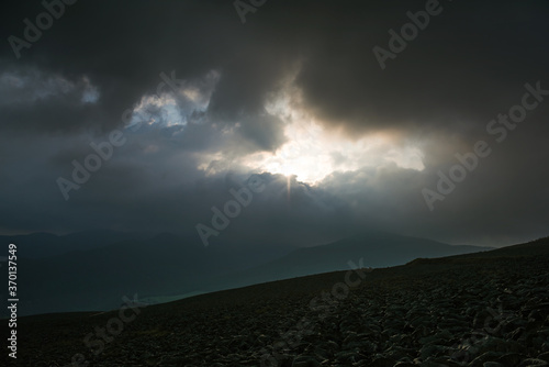 Scenery of the beautlful panoramic green cabbage farm in high slope mountain with tyndall effect background. photo