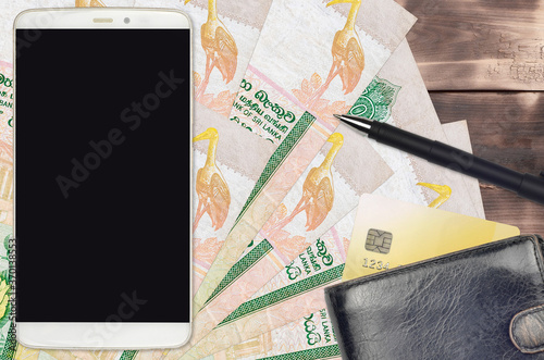 10 Sri Lankan rupees bills and smartphone with purse and credit card. E-payments or e-commerce concept. Online shopping and business with portable devices photo