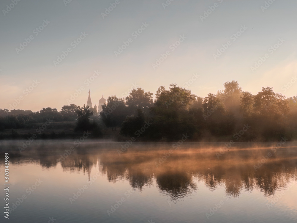 Beautiful morning landscape with fog over the lake Beautiful morning landscape with fog over the lake