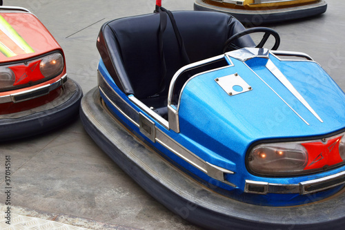 Old empty electric bumper cars in autodrom in fairground attractions at amusement park. 