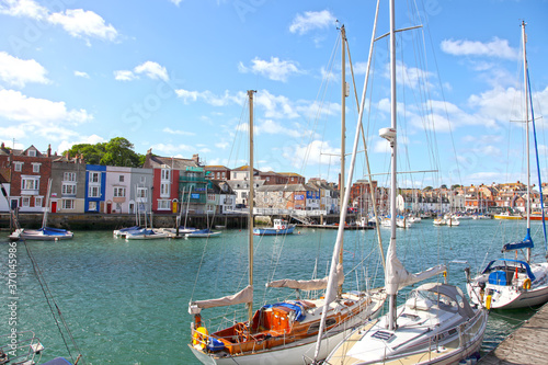 Sailing boats in the old town of Weymouth Harbour in Dorset, England, UK.